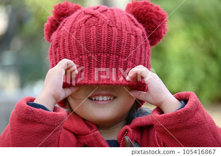 Toddler wearing a knit hat deeply 105416867