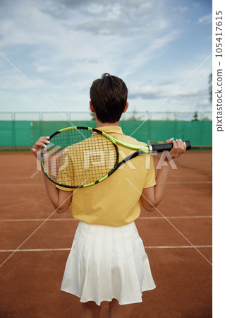Back view on young teenage woman tennis player holding racket 105417615