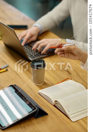 Closeup office workers hand over desk table during business meeting Closeup office workers hand over desk table during business meeting 105417674