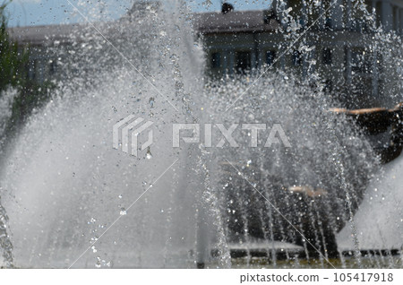 Tall fountain spraying from the floor in sunny day. 105417918