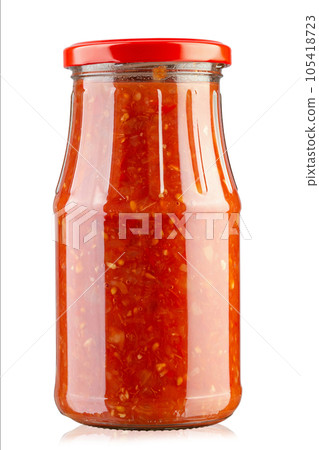 Glass jar of homemade sauce adjika isolated on white background. File contains clipping path. Glass jar of homemade sauce adjika isolated on white background. File contains clipping path. 105418723