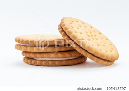Stacked sandwich biscuits with pink cream filling. Sandwich cookies lie one on top of the other Stacked sandwich biscuits with pink cream filling. Sandwich cookies lie one on top of the other 105418797