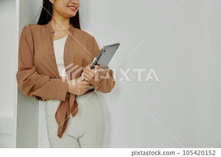 Unrecognizable smiling woman holding laptop isolated on white. 105420152