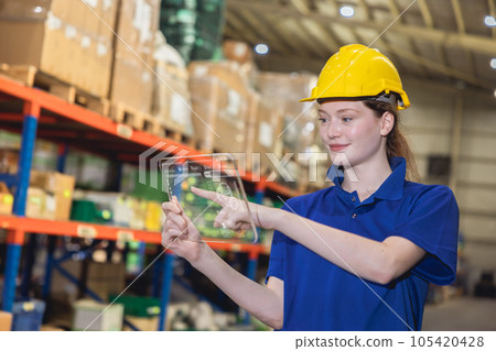 modern worker using digital tablet device with logistics inventory management software to control loading monitor cargo warehouse goods 105420428