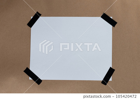 White paper sticked with tape in edge 105420472