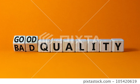 Good or bad quality symbol. Turned wooden cubes and changed words bad quality to good quality. Beautiful orange table orange background. Business good or bad quality concept, copy space. 105420619