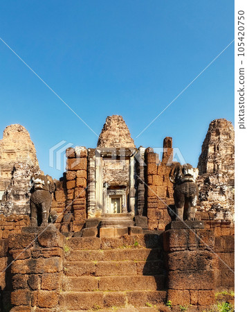 Blue cloudless sky over ancient Khmer ruins, stone steps, East Mebon. 105420750