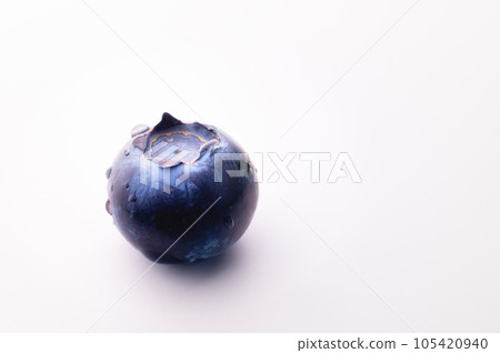 Blueberries on a white background. One blueberry wet with water drops on background Blueberries on a white background. One blueberry wet with water drops on background 105420940