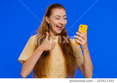 Happy excited winner woman use smartphone say wow yes found out great big win good news lottery 105421302