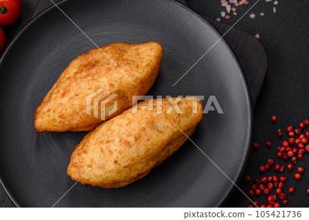 Delicious baked potato cutlet stuffed with chicken and vegetables, spices and salt 105421736