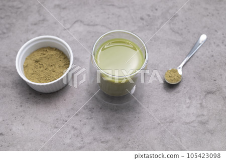 Top View Glass Of Smoothie, Juice With Hemp Protein Powder On Table. Bowl And Spoon With Plant Derived Protein from Cannabis Plant. Superfood, Dieting. Horizontal Plane Flat Lay 105423098