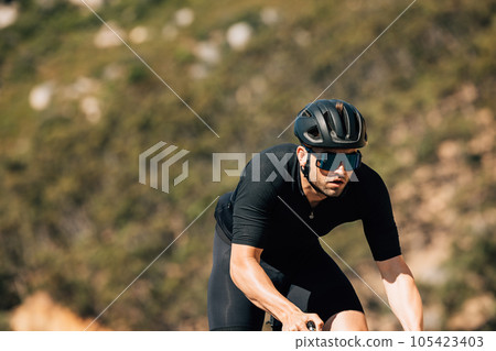 Male cyclist in black sportswear during training 105423403