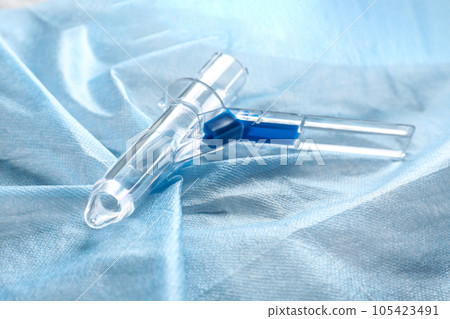 Anoscope on light blue fabric. Hemorrhoid treatment Anoscope on light blue fabric. Hemorrhoid treatment 105423491