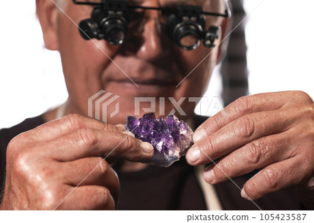 Professional jeweler working with beautiful amethyst, closeup Professional jeweler working with beautiful amethyst, closeup 105423587