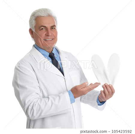 Male orthopedist showing insoles on white background Male orthopedist showing insoles on white background 105423592