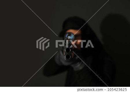 Professional killer on black background, focus on sniper rifle Professional killer on black background, focus on sniper rifle 105423625