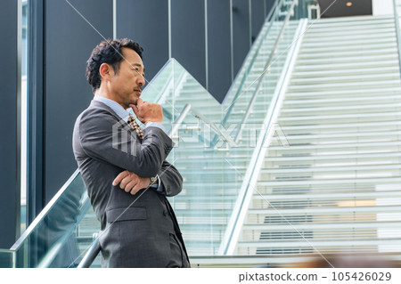 Middle-aged businessman thinking in the office 105426029