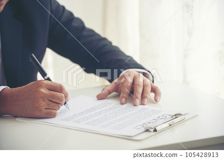 Asian business man using pen signing on new contract to starting projects in conference room. Close up manager businessman hands sign contract working meeting. Business agreement concepts. 105428913