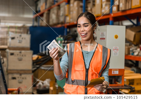 Engineer warehouse staff employee happy glad to recieve salary increase. industry woman worker happy glad with overtime bonus money payday 105429515