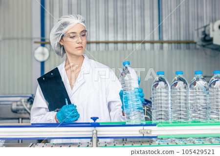 worker in drinking water factory. women workers caucasian labor in beverage clean production conveyor belt mineral water manufactory. worker in drinking water factory. women workers caucasian labor in beverage clean production conveyor belt mineral water manufactory. 105429521