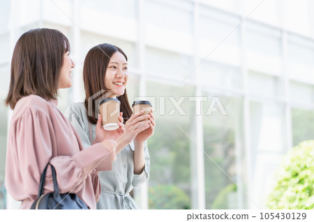 Asian woman walking with coffee 105430129