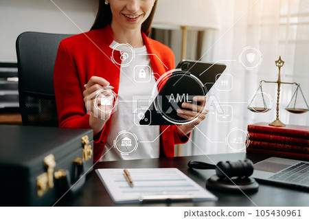 AML Anti Money Laundering Financial Bank Business Concept. judge in a courtroom using laptop and tablet with AML anti money laundering icon on virtual screen. . AML Anti Money Laundering Financial Bank Business Concept. judge in a courtroom using laptop and tablet with AML anti money laundering icon on virtual screen. . 105430961