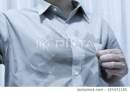 A man whose clothes are wet with sweat on his chest A man whose clothes are wet with sweat on his chest 105431185