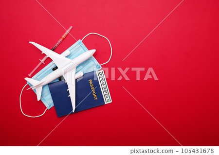 Syringe, toy plane, medical mask and passport with Covid-19 test 105431678