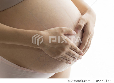Pregnant woman putting her hand on her stomach with stretch marks and midline Pregnant woman putting her hand on her stomach with stretch marks and midline 105432158