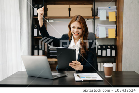 Asian business woman are delighted and happy with the work they do on their tablet, laptop and taking notes at office.. Asian business woman are delighted and happy with the work they do on their tablet, laptop and taking notes at office.. 105432524