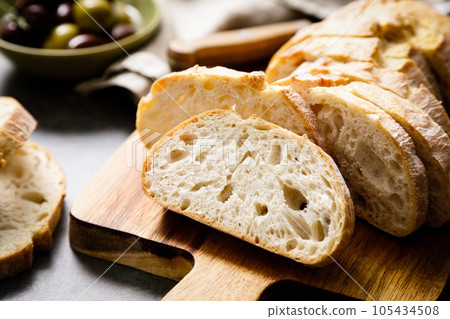 Ciabatta bread sliced on a board, top view 105434508