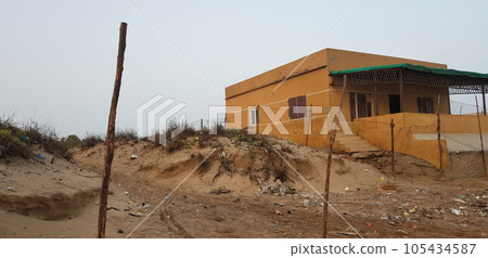 an old hut or house on sandy hawksbay beach 105434587