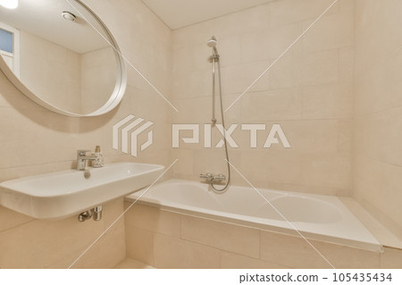 a bathroom with a sink, mirror and bathtub on the wall next to the tub in the shower stall 105435434
