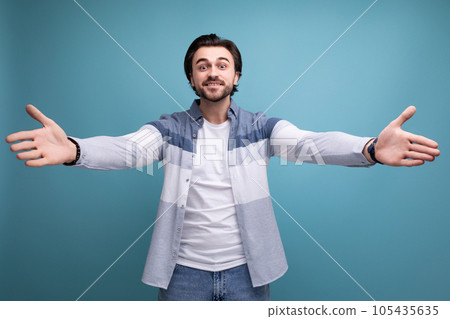 a kind brunette guy in a model appearance wants to cuddle on a studio background a kind brunette guy in a model appearance wants to cuddle on a studio background 105435635