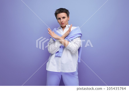portrait of a young woman with a short haircut in a stylish casual look with a gesture of 105435764