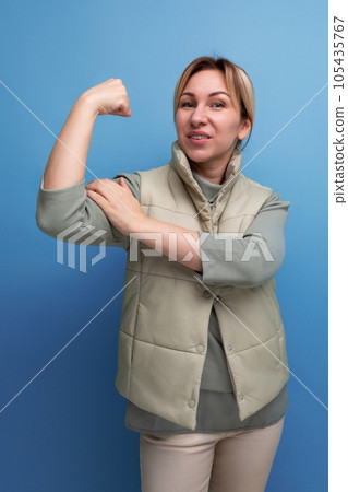 strong 30s millennial woman in casual clothes showing muscles strong 30s millennial woman in casual clothes showing muscles 105435767
