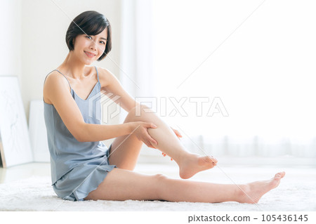 Young woman doing skin care for her legs Young woman doing skin care for her legs 105436145