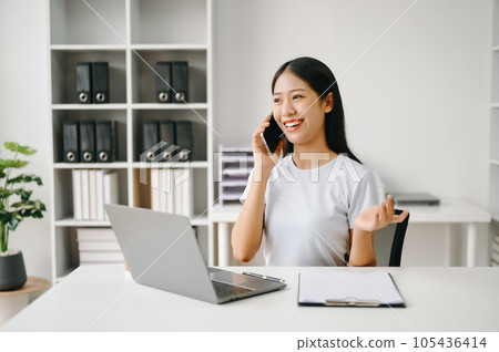 Successful Asian Businesswoman Analyzing Finance on Tablet and Laptop at Office Desk tax, report, accounting, statistics, and analytical research concept. Successful Asian Businesswoman Analyzing Finance on Tablet and Laptop at Office Desk tax, report, accounting, statistics, and analytical research concept. 105436414