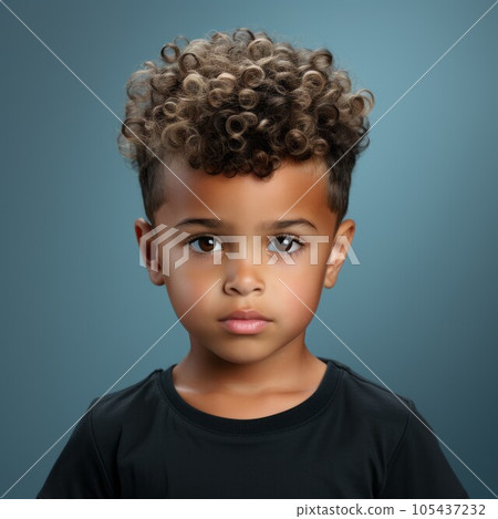 Portrait of a little Latin American boy with brown curly hair. Closeup face of a serious Latin child on a dark background looking at camera. Front view of an unsmiling kid in casual clothes. 105437232