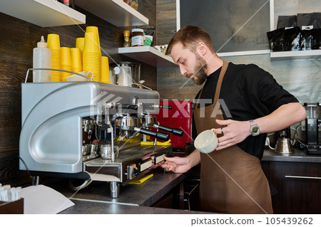 Young male barista preparing coffee in coffee shop 105439262
