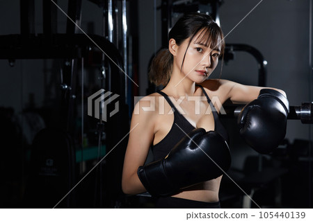 A young woman training at the gym A young woman training at the gym 105440139