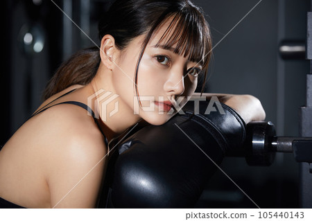 A young woman training at the gym A young woman training at the gym 105440143