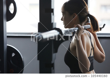 A young woman training at the gym A young woman training at the gym 105440160