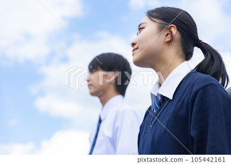 High school boy and girl looking up at the sky High school boy and girl looking up at the sky 105442161