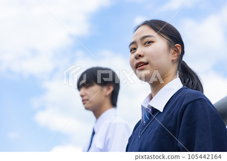 High school boy and girl looking up at the sky High school boy and girl looking up at the sky 105442164