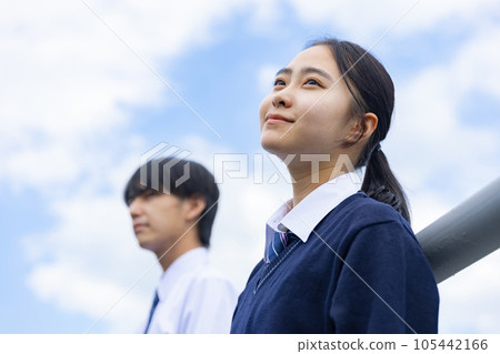 High school boy and girl looking up at the sky High school boy and girl looking up at the sky 105442166