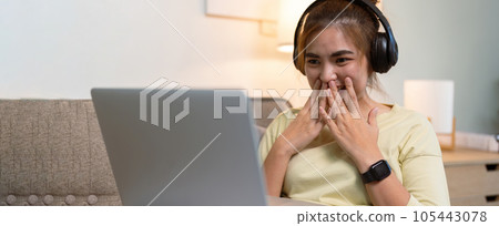 Concept of relaxation at home, Happy Asian woman watching online movie via laptop in living room Concept of relaxation at home, Happy Asian woman watching online movie via laptop in living room 105443078
