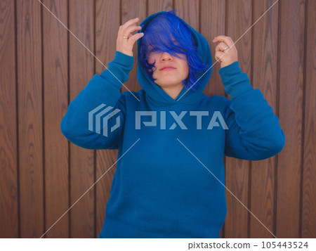Female wearing light blue oversize hoodie and jeans 105443524