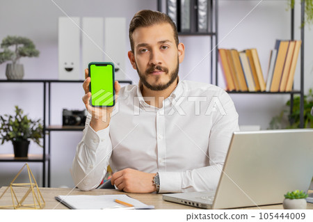 Developer business man hold smartphone with green screen chroma key recommend application sale offer 105444009