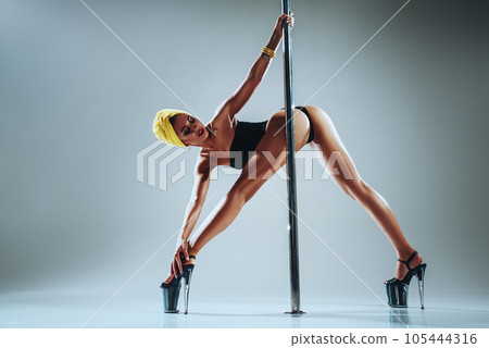 Woman poledancing 105444316